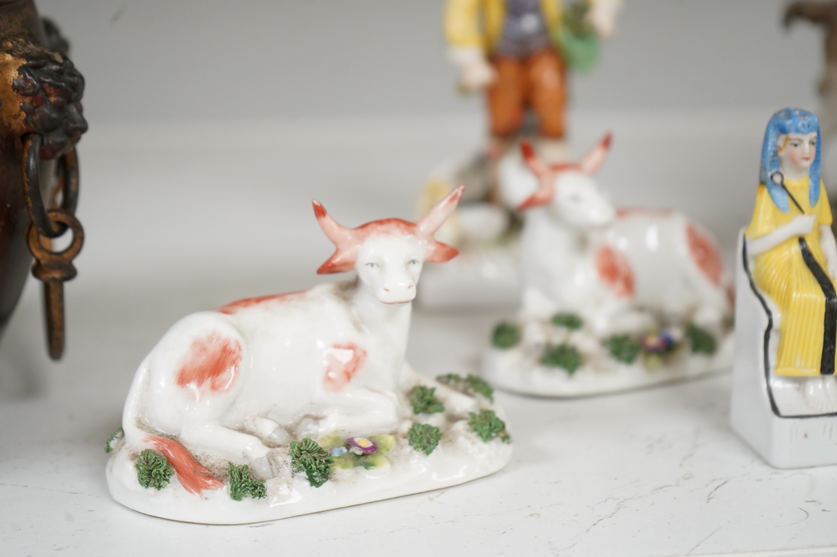 Two Derby porcelain seated figures emblematic of summer and autumn and a collection of Continental porcelain figures to include a pair of recumbent cows, largest 18cm high